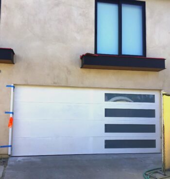 White modern flush garage door with horizontal windows in Laguna Beach, CA