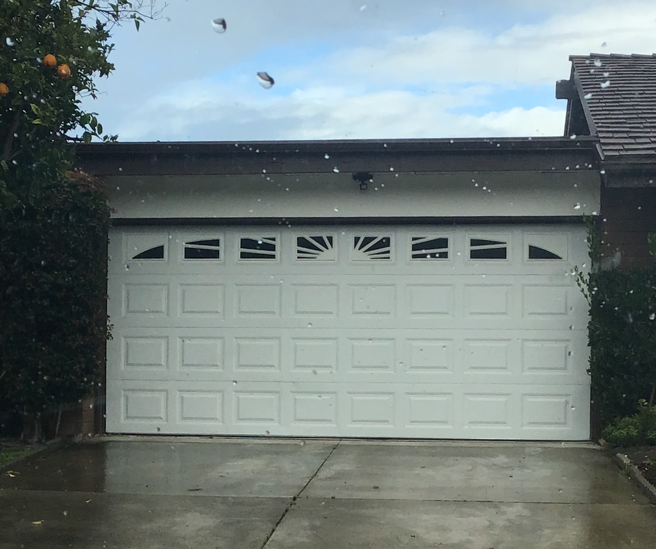 White short panel garage door in San Clemente, CA before replacement