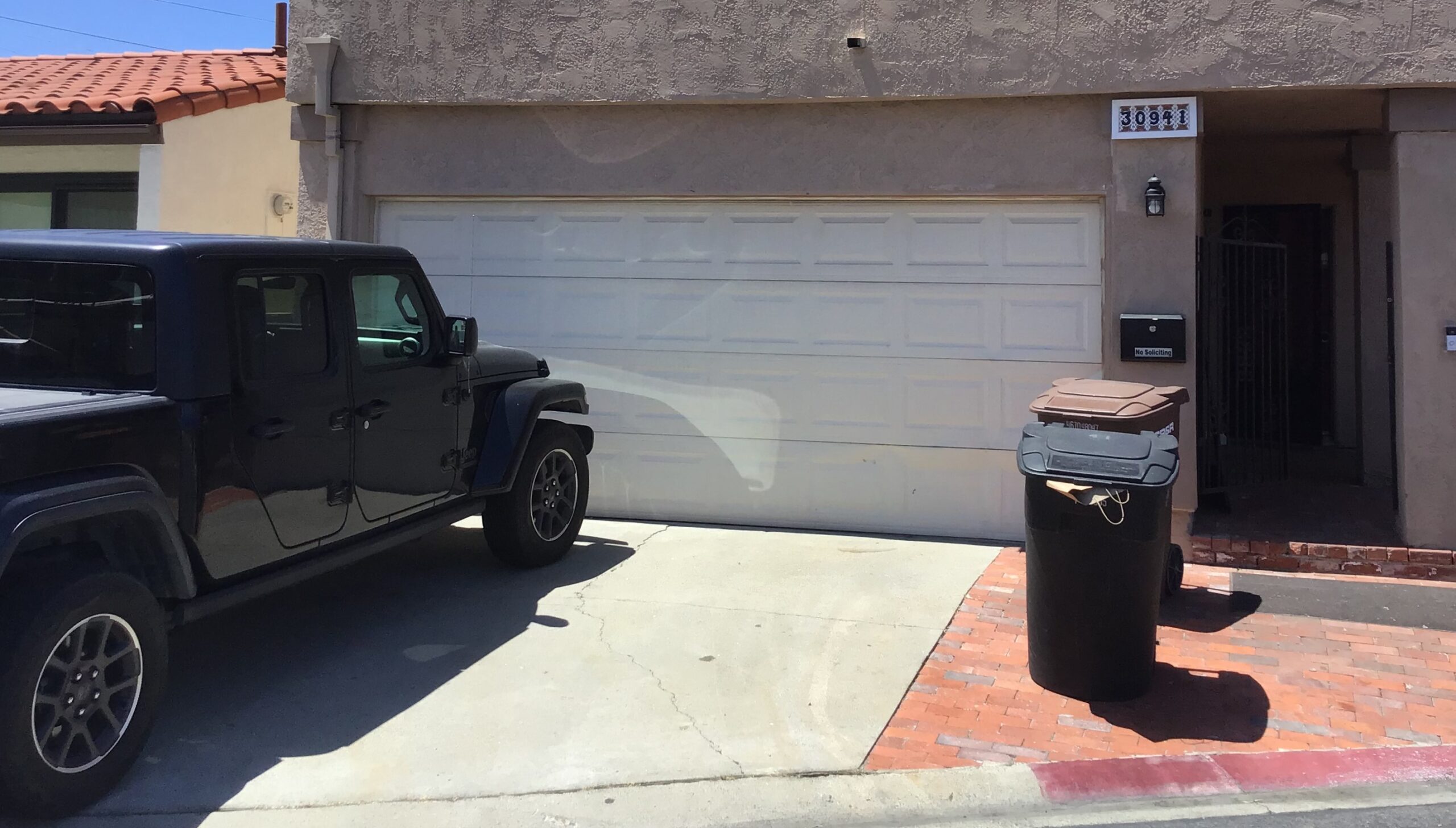 white short panel garage door in San Juan Capistrano before replacement