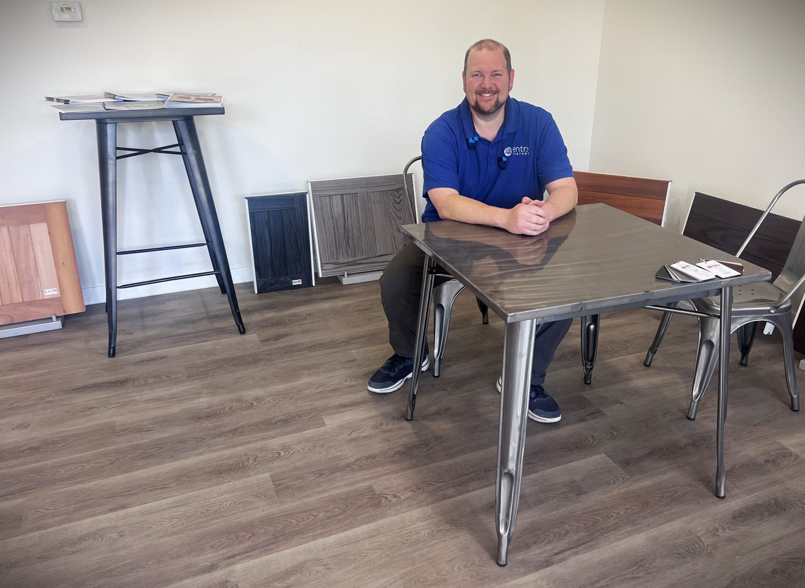 Sales manager sitting at table in Tustin garage door showroom