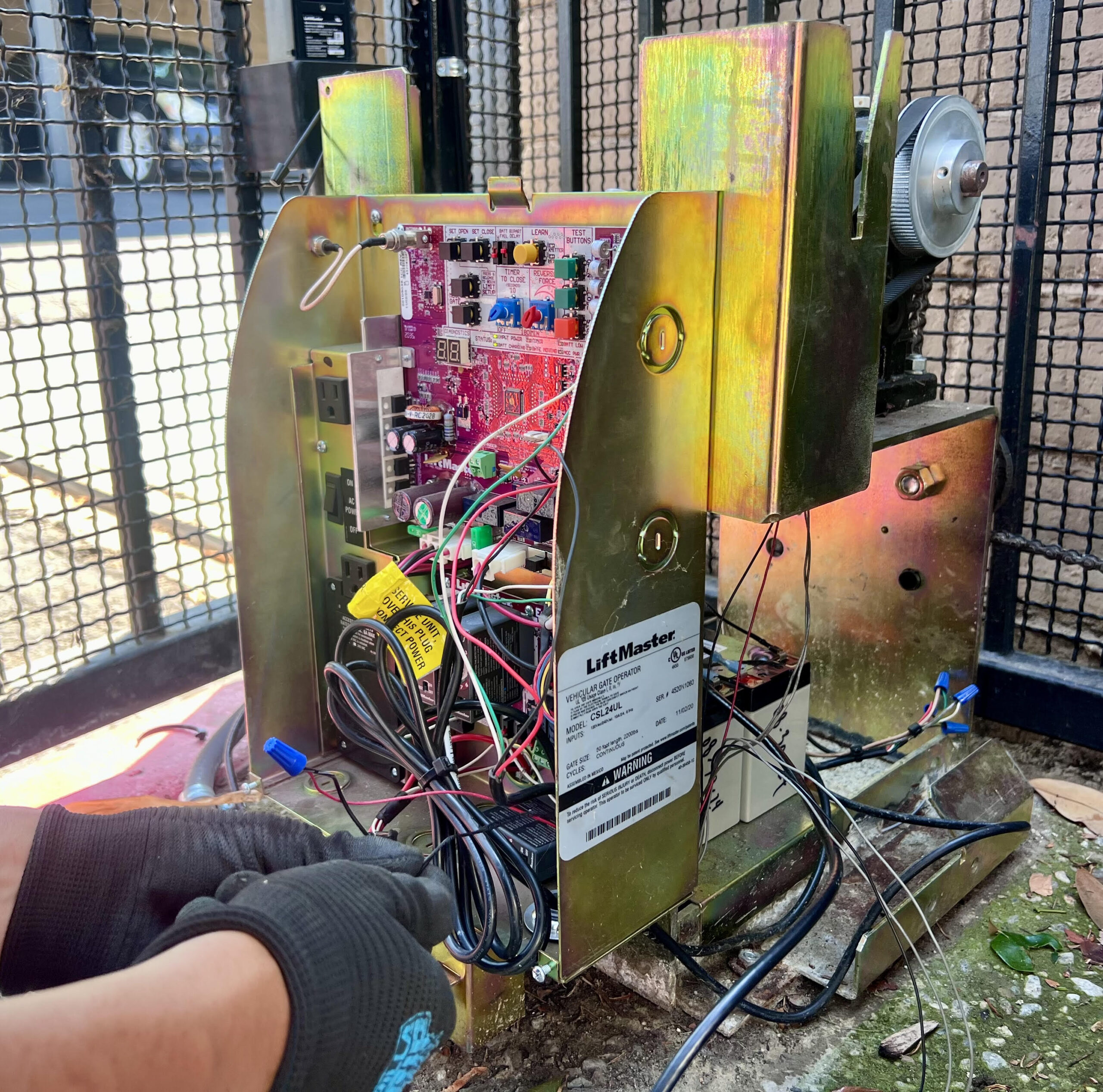 gate technician repairing gate motor