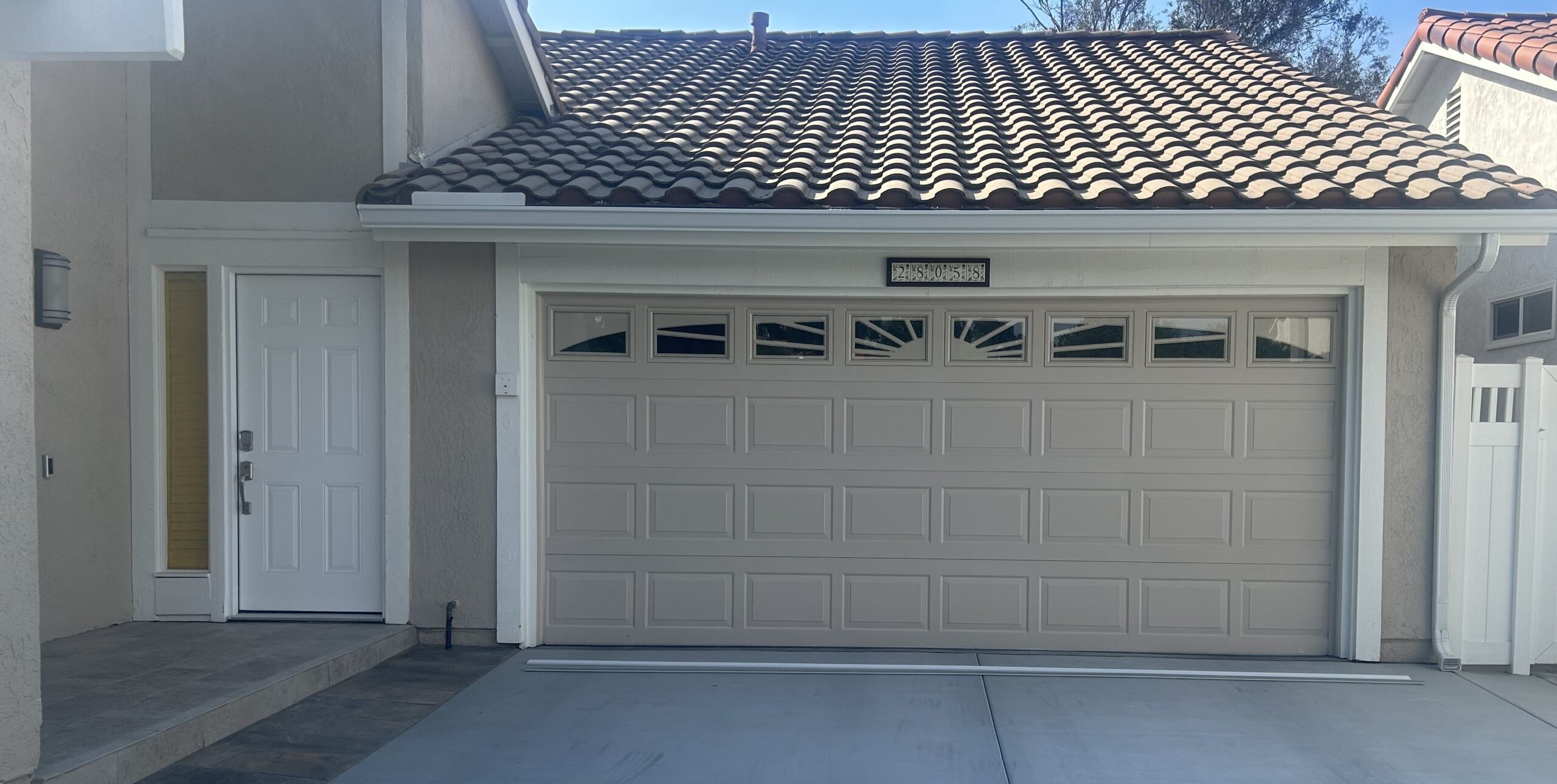 short panel garage door with sunburst window in Mission Viejo before replacement
