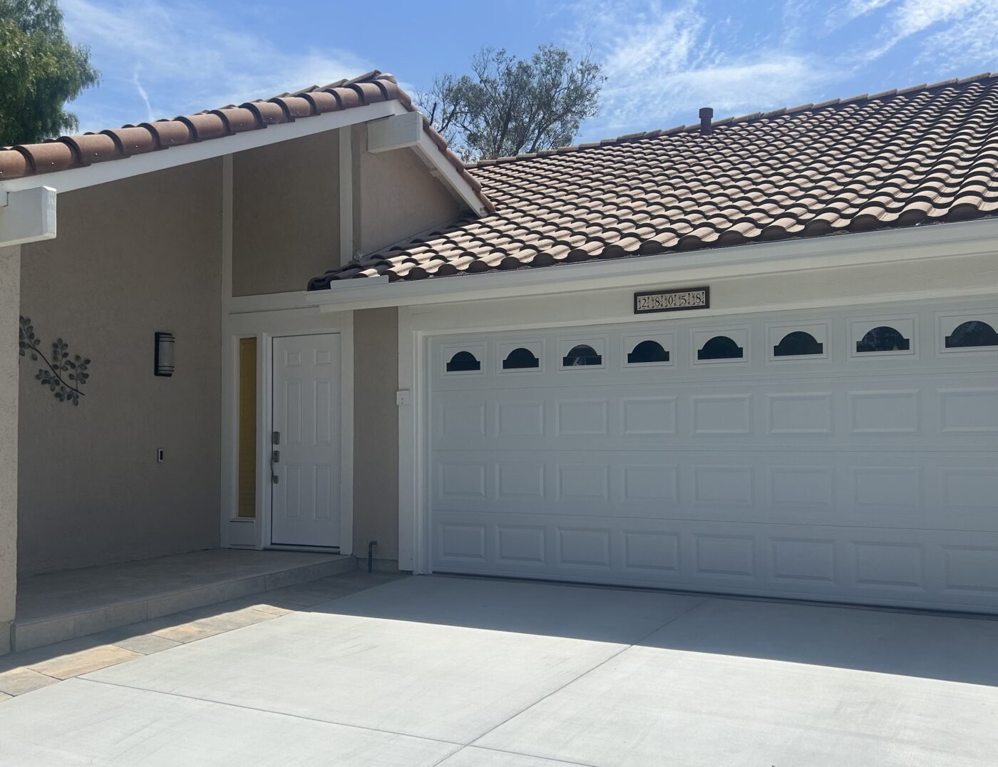 white traditional garage door with cathedral windows in Mission Viejo after retrofit construction