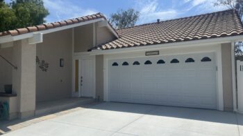 white traditional garage door with cathedral windows in Mission Viejo after retrofit construction