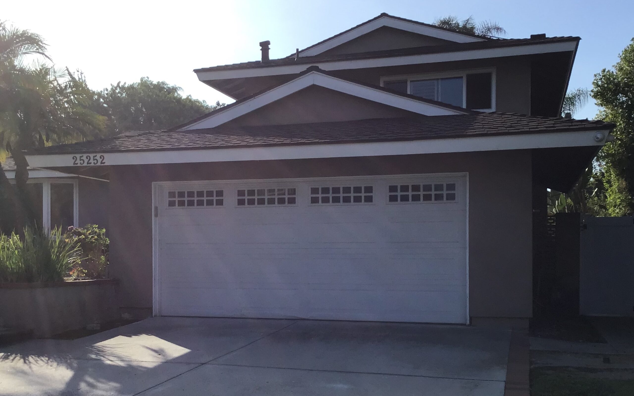 white long panel steel garage door with windows