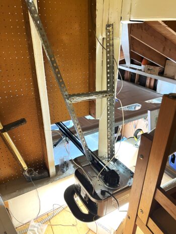 image of a garage door opener with a hole cut so it can be inside an attic