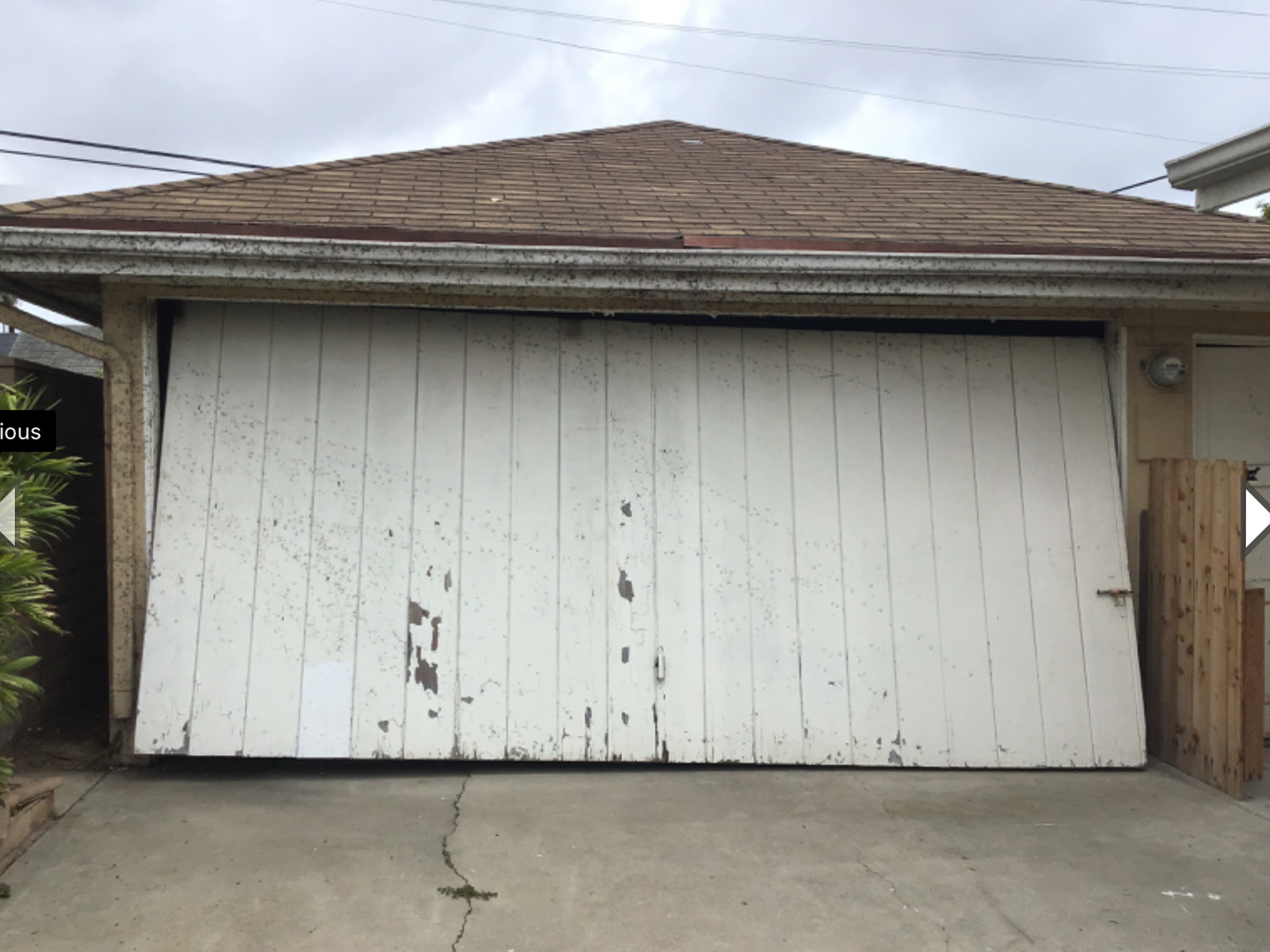 old wood one piece white garage door in San Clemente before replacement