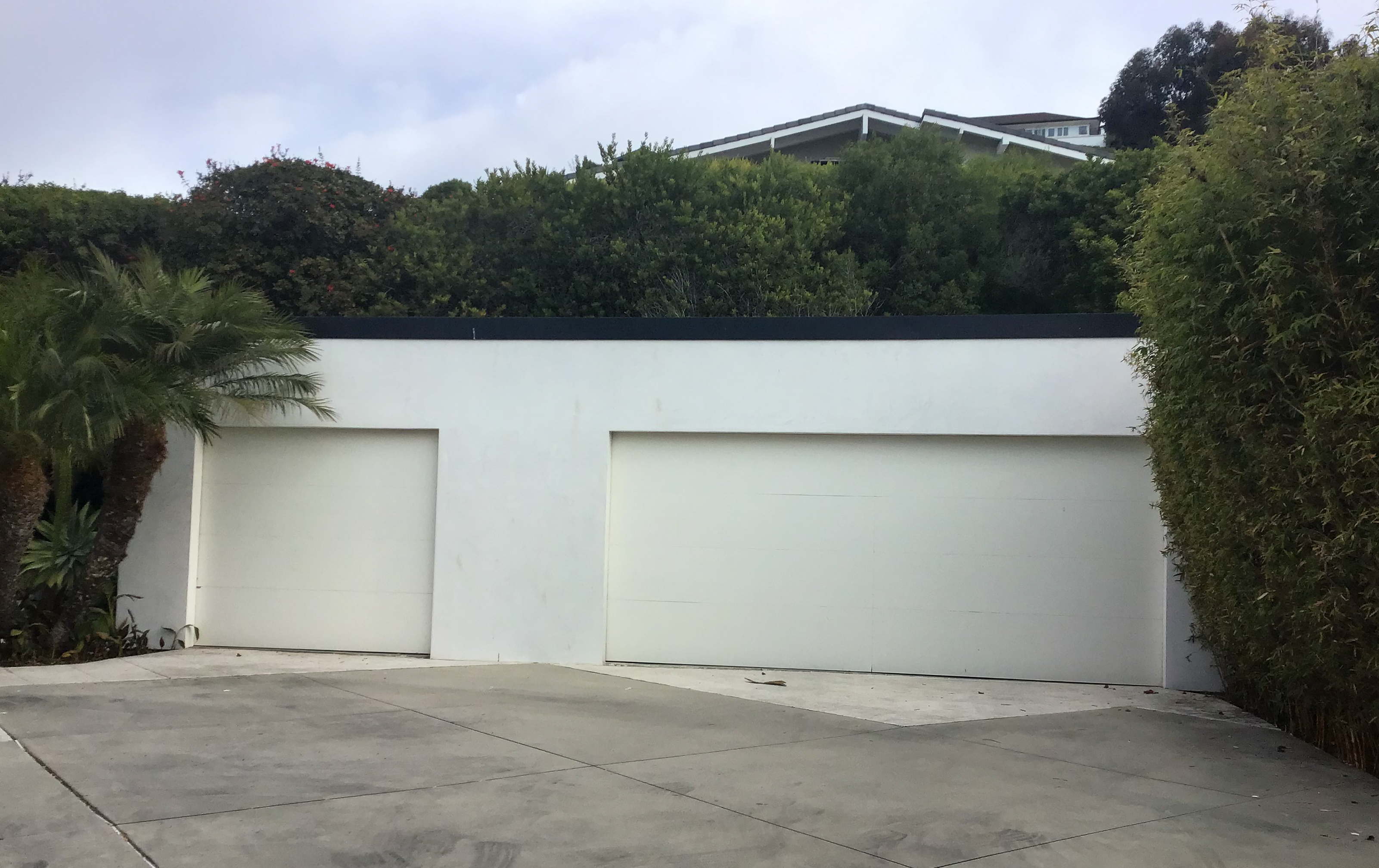 white wood sectional garage door in dana point before retrofit